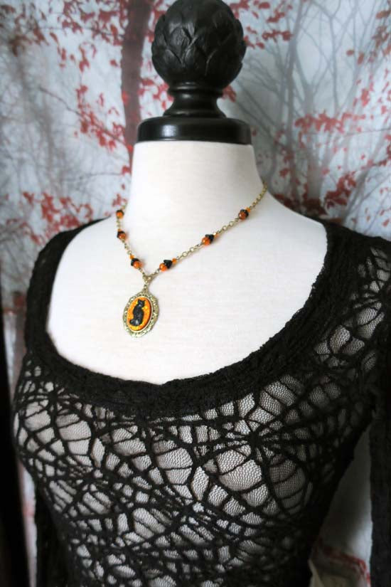 Black Cat Necklace - small with orange glitter - antique brass