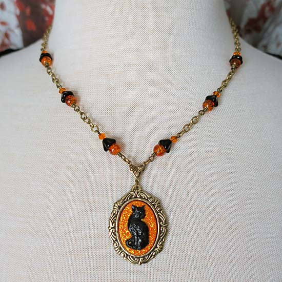 Black Cat Necklace - small with orange glitter - antique brass